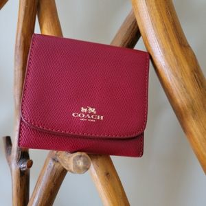 Coach Red Trifold small wallet with 11 card slos, bill slot and coin pouch.